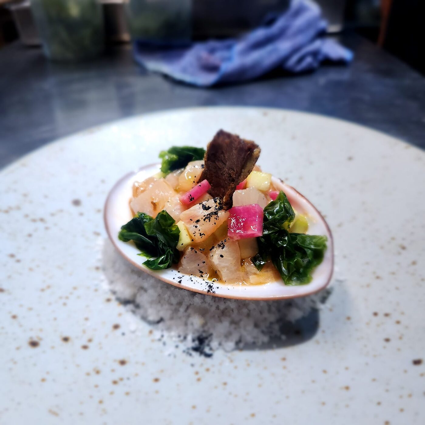 Aguachile with pickled jicama and charred pepper, served over salt