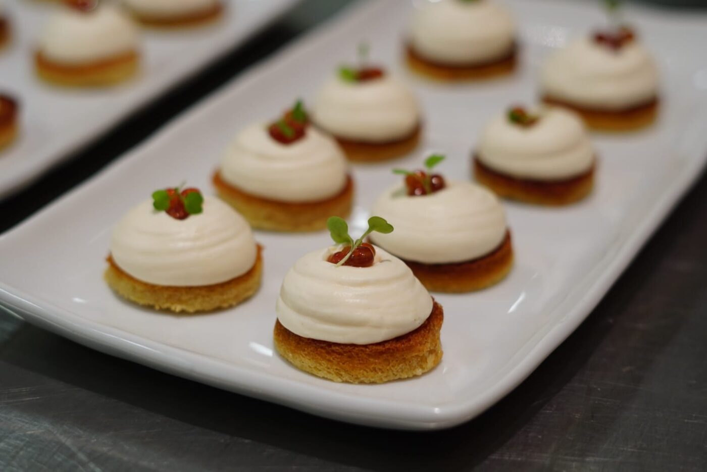 Salmon mousse crostini with citrus pearl and micro herbs