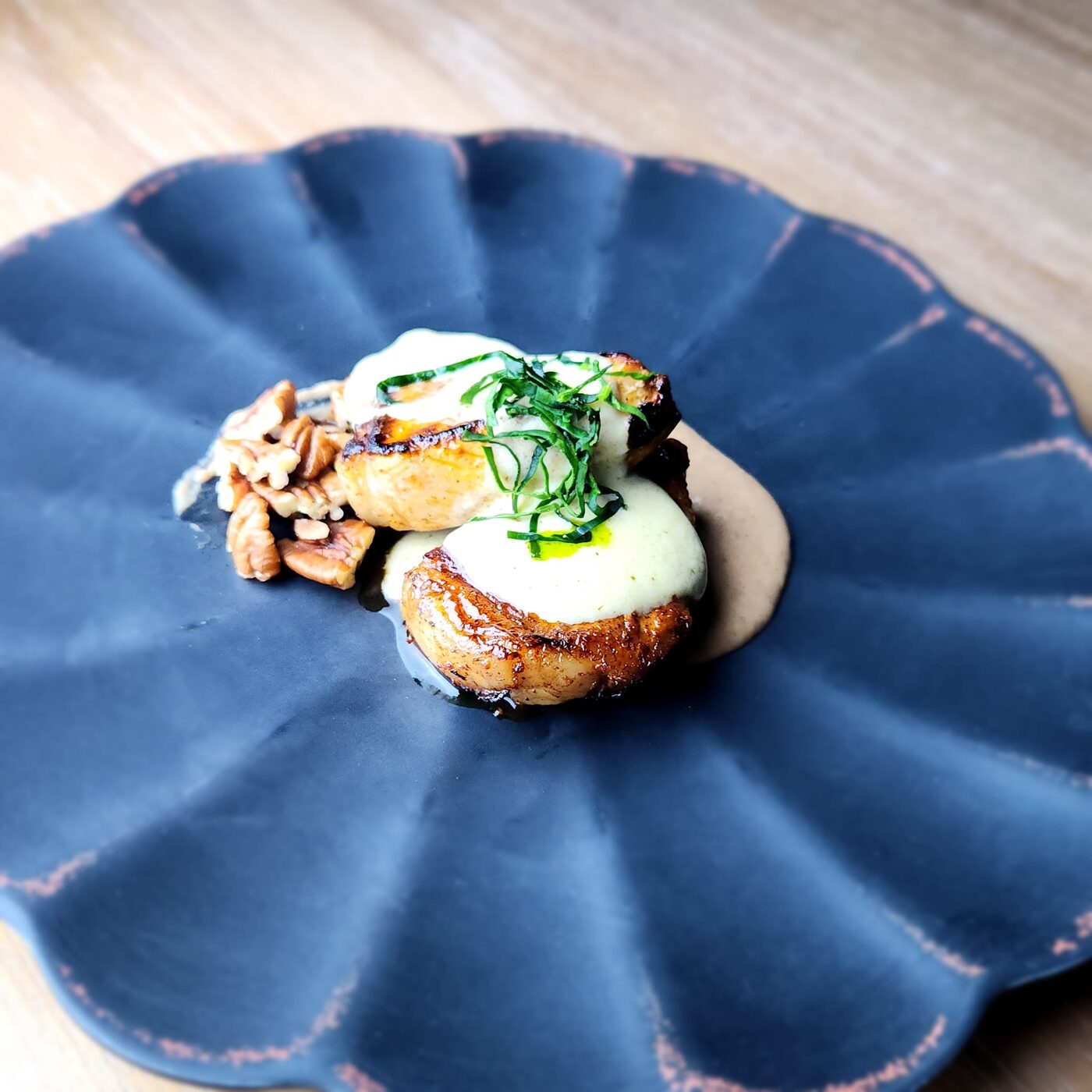 Pan-seared pork medallions with candied pecans, brown butter béchamel, and whipped pinto bean purée